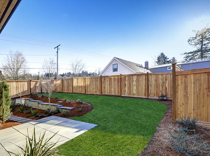 Sloped backyard surrounded by wooden fence Luxury springfield il