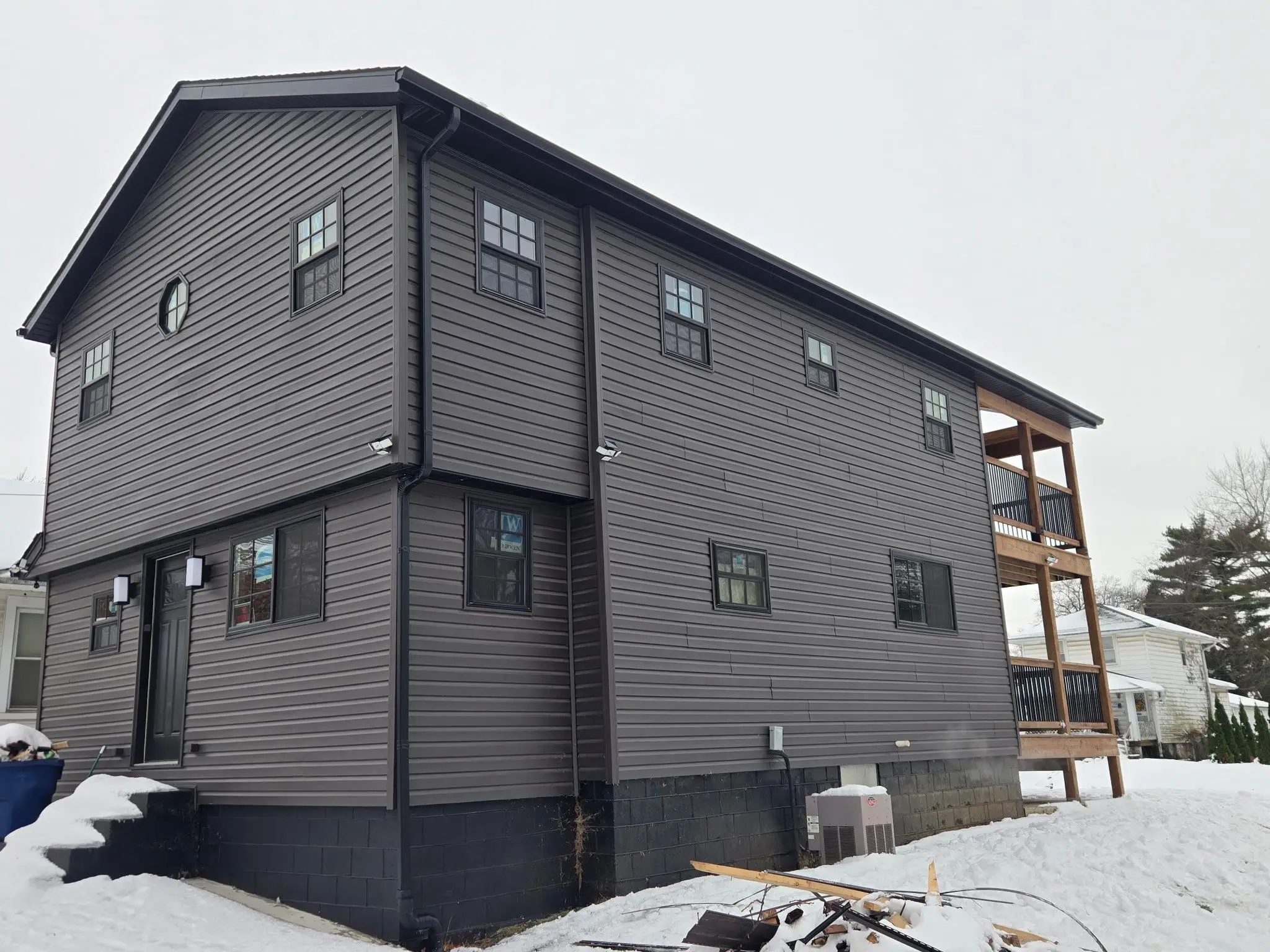 Finished exterior of fully renovated custom home with covered porches in Springfield, IL