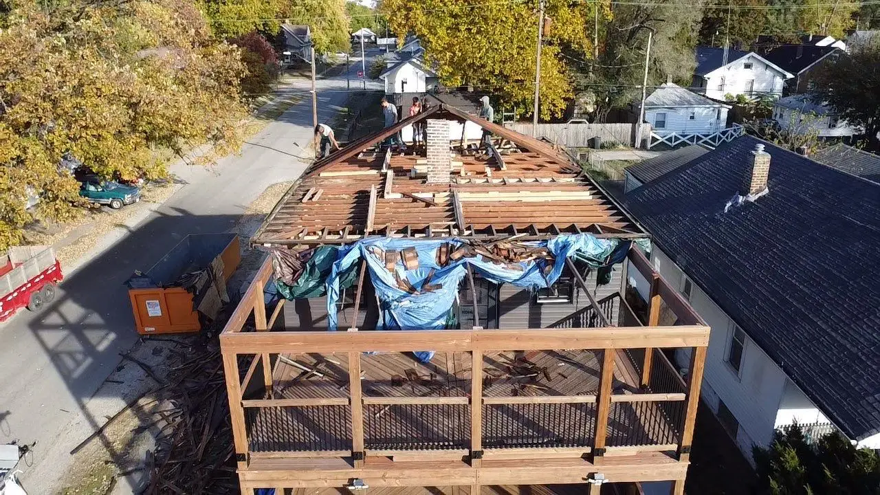 Roof removal underway with framing exposed during extensive home renovation in Springfield, IL