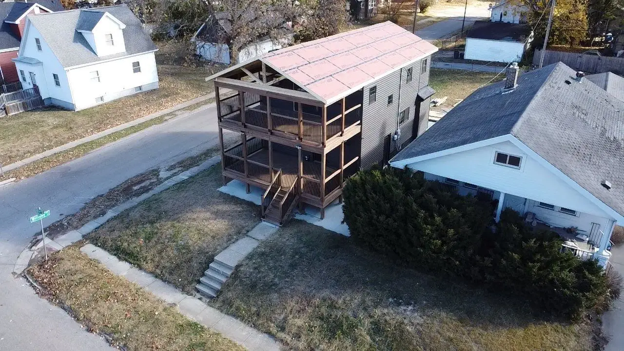 New roof sheathing installed on custom home addition before shingle installation in Springfield, IL
