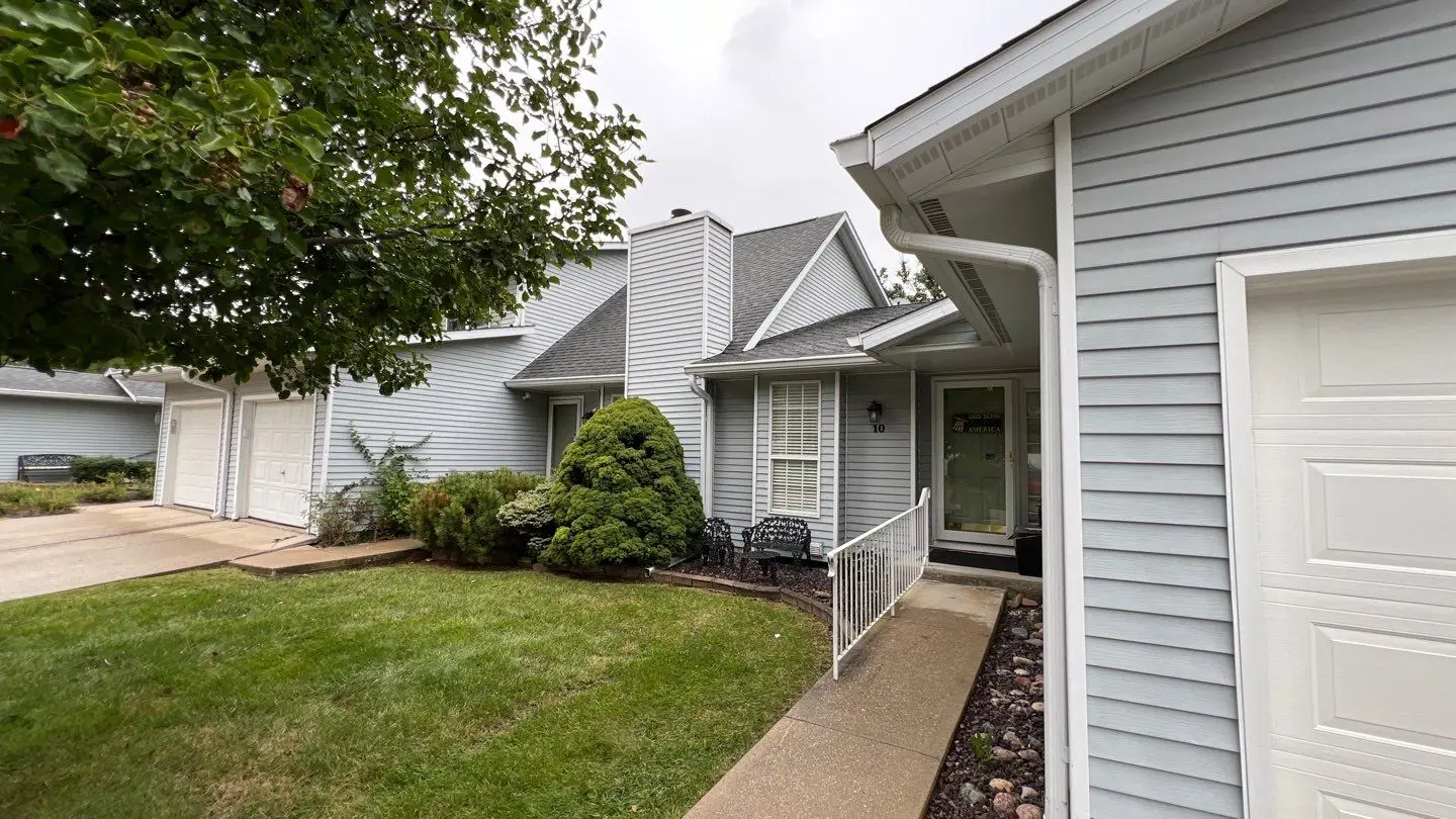 Front entrance of townhouse before exterior siding replacement project in Springfield, IL