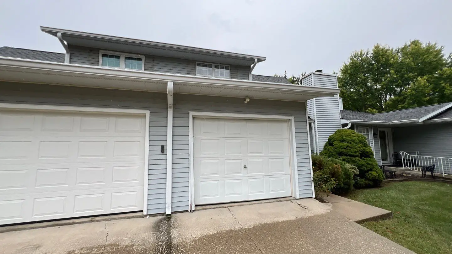Two-car garage and front façade prior to exterior renovation in Springfield, IL