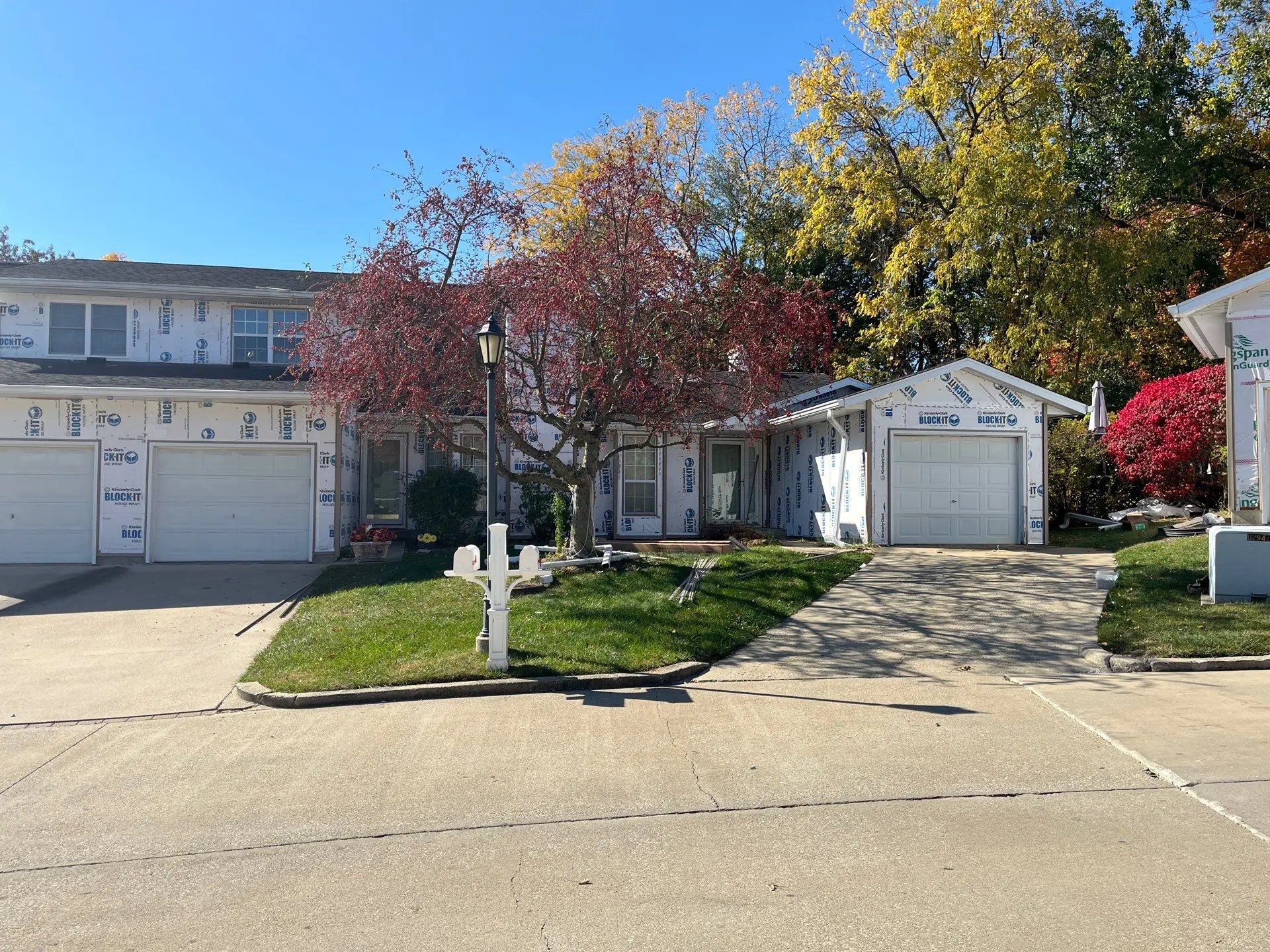 Townhouse wrapped with house wrap before new vinyl siding installation in Springfield, IL