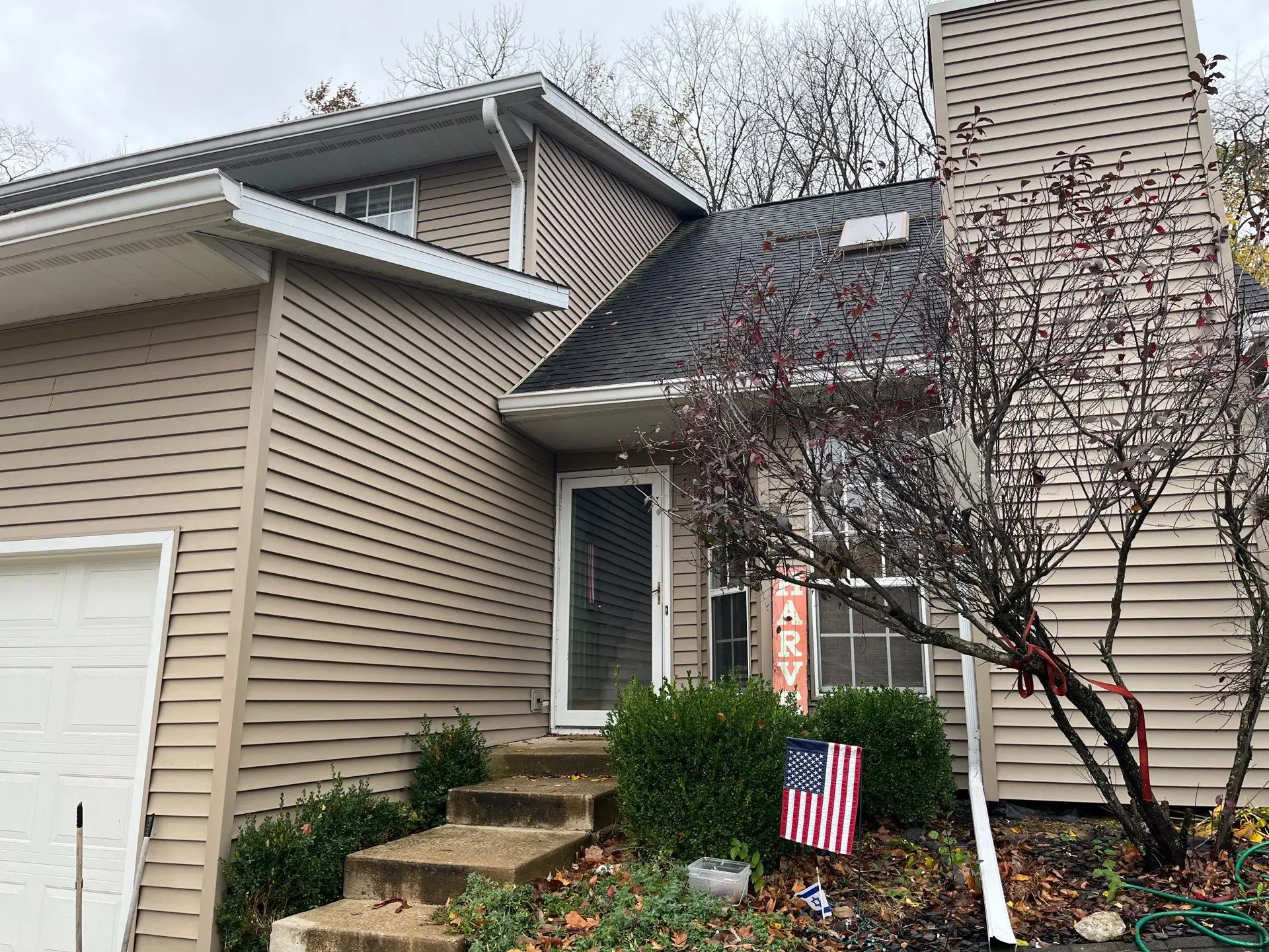 Front entrance of home before exterior siding replacement and renovation in Springfield, IL