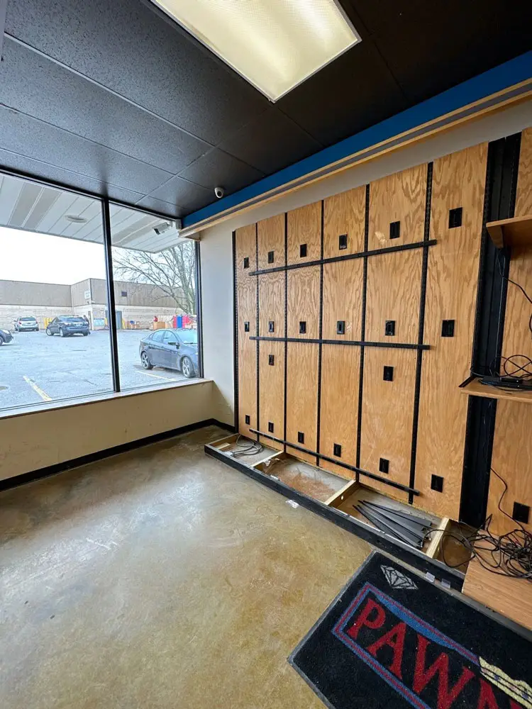 Commercial storefront interior with wall framing removed during renovation in Moline, IL