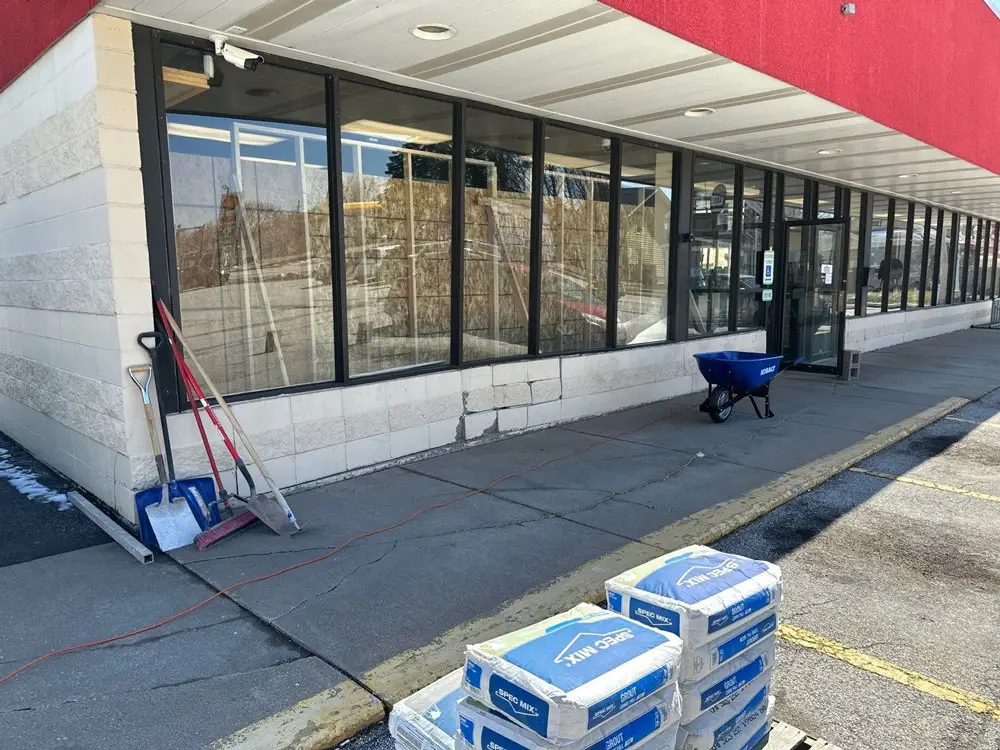 Retail storefront with construction materials staged for renovation in Moline, IL