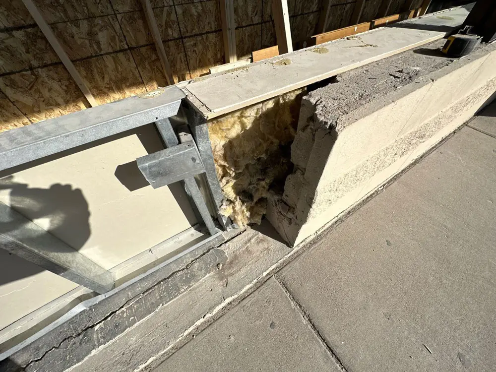 Damaged storefront foundation and framing exposed during commercial renovation in Moline, IL