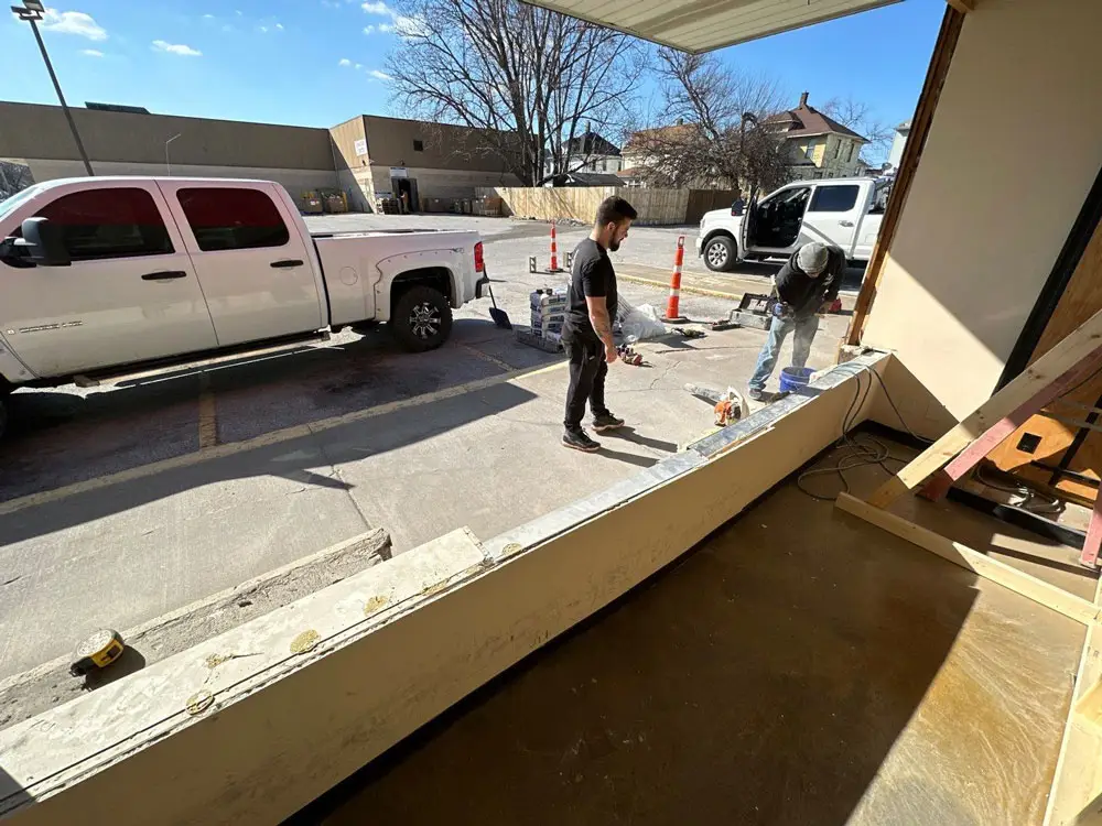 Commercial storefront wall demolition and structural repair in progress in Moline, IL