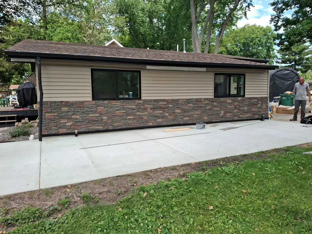 Finished residential exterior remodeling with updated siding, stone accents, and driveway in Springfield, IL