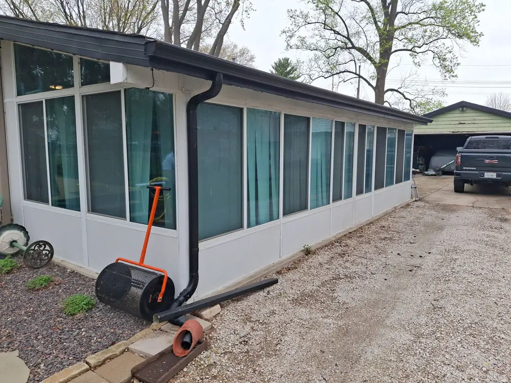 Completed exterior renovation with new gutters and updated sunroom in Springfield, IL