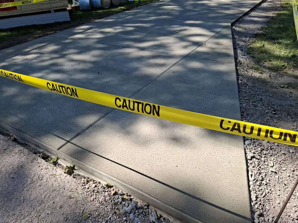 Newly poured residential concrete driveway curing after installation in Springfield, IL